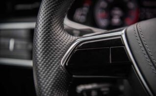 A close up of a luxury car’s steering wheel.