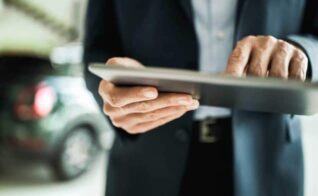 A dealer completes their confidential application on a tablet.